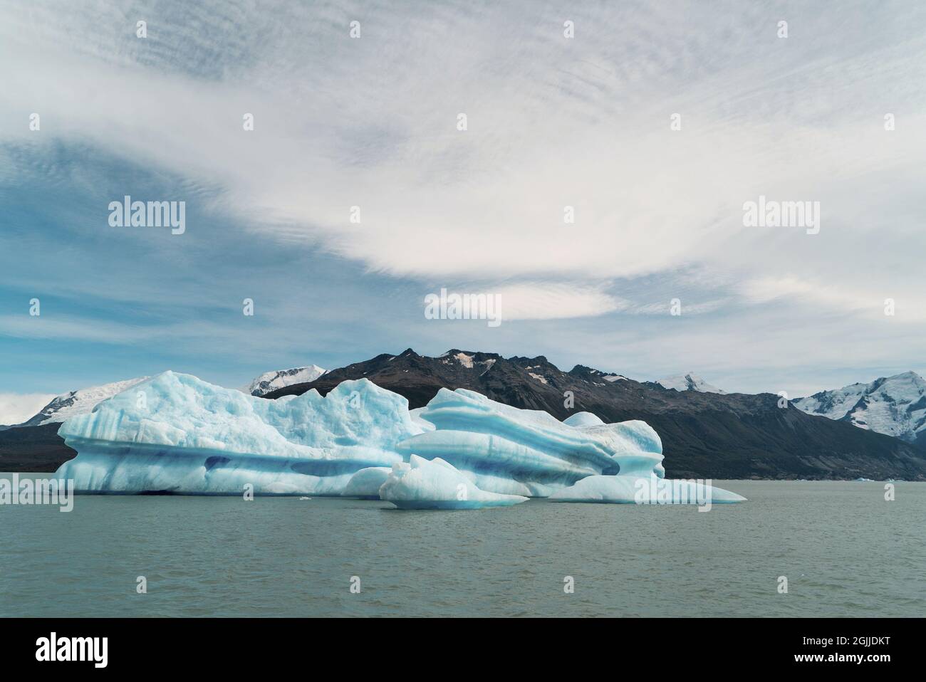 Huge block of ice called an iceberg floating adrift through the water