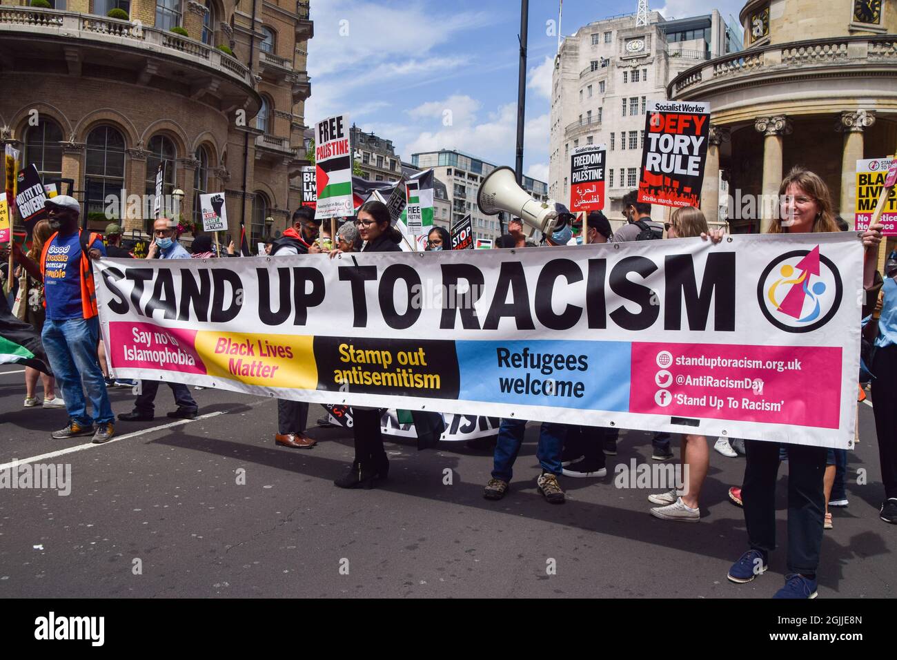 London, United Kingdom. 26th June 2021. Protesters hold a 'Stand Up To Racism' banner on Regent Street. Several protests took place in the capital, as pro-Palestine, Black Lives Matter, Kill The Bill, Extinction Rebellion, anti-Tory demonstrators, and various other groups marched through Central London. Stock Photo
