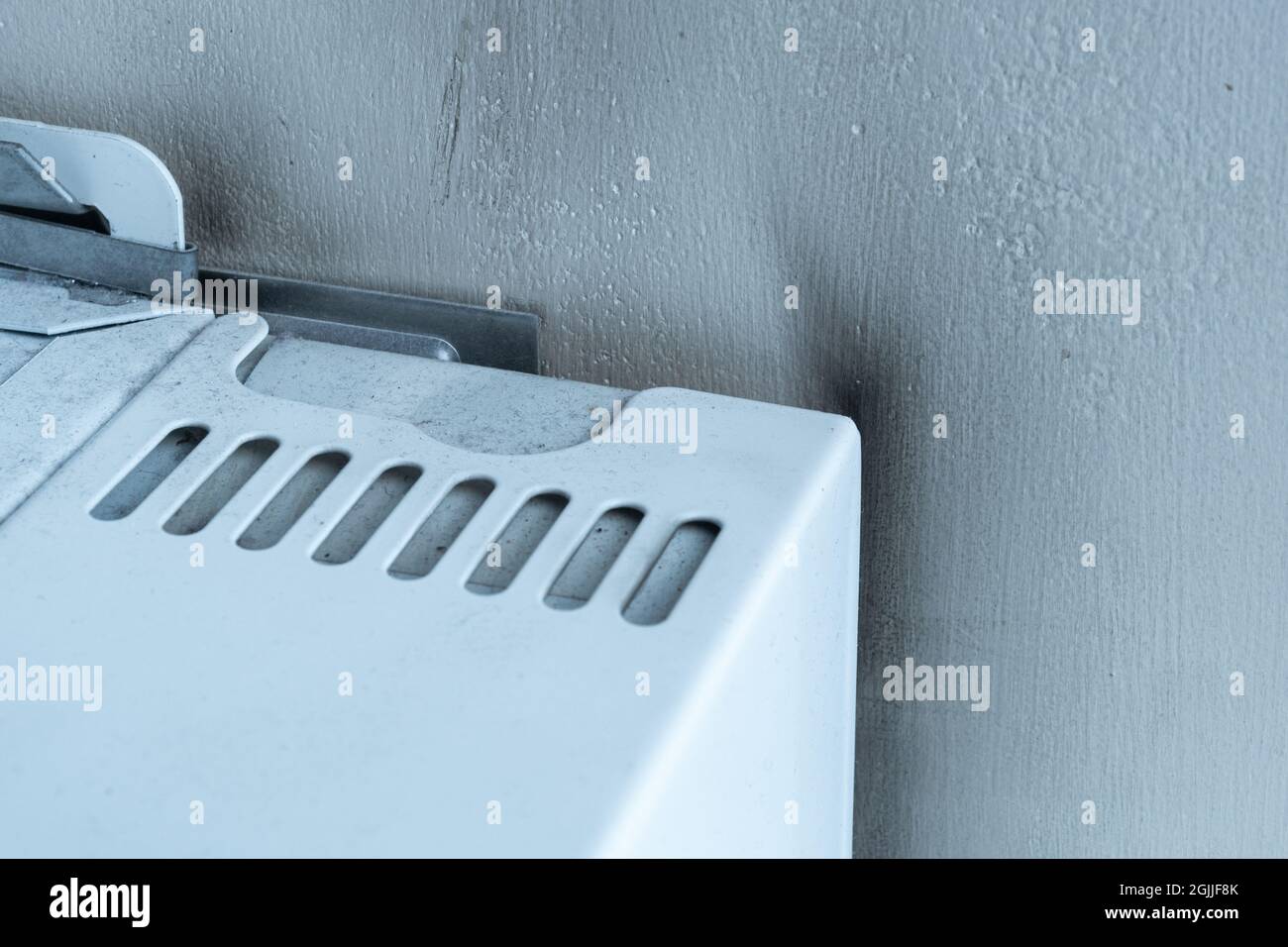 Black soot marks or stains on the wall around a gas boiler, indicator