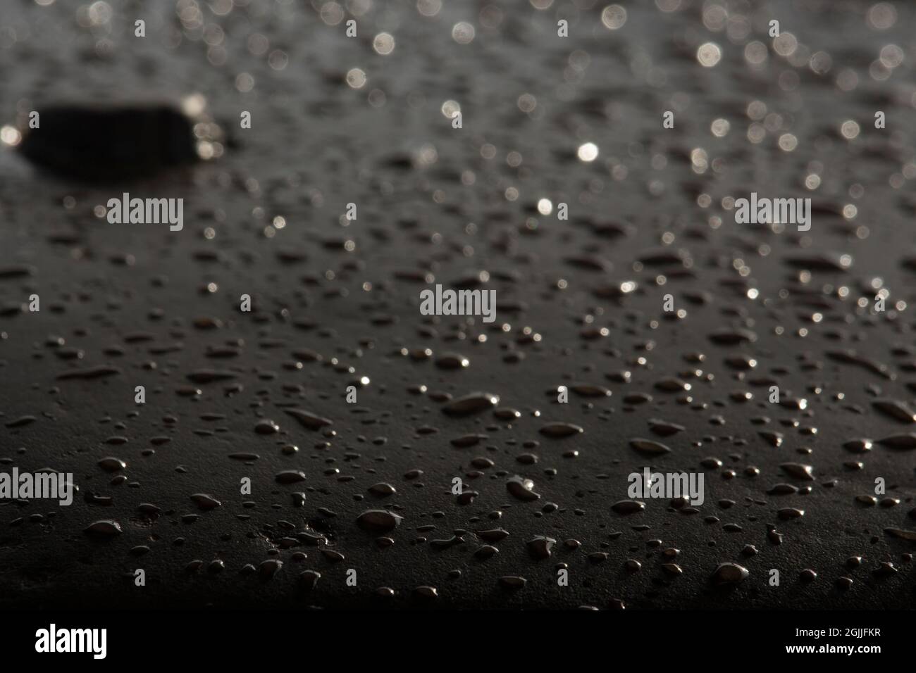 The rain water falling on the iron bar has created such a scene. Stock Photo