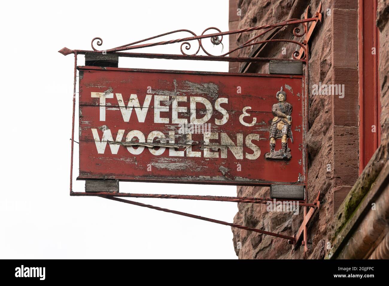 Scottish tweed - Tweeds and woollens sign outside the now closed Haggarts Tweeds and Woollens store, Aberfeldy, Scotland, UK Stock Photo