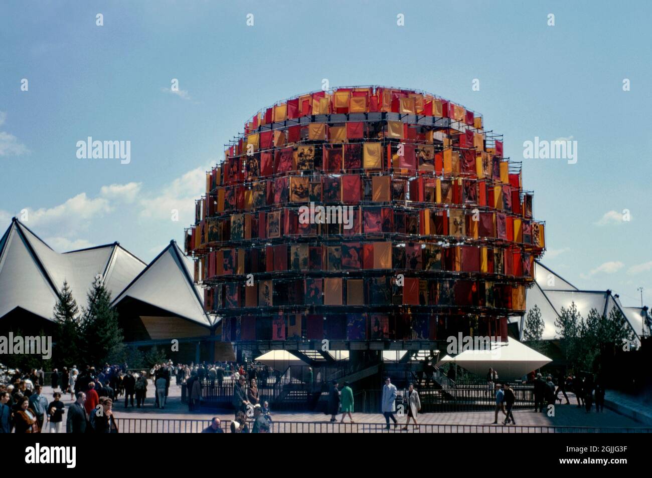 The Canadian Pavilion at Expo 67, Montreal, Quebec, Canada in 1967. The home pavilion featured an inverted pyramid structure (Katimavik) as well as the attraction here – a walk-through an attraction called the ‘People Tree’. This was composed of images on orange and red nylon fabric (tree leaves), the colours representing autumn leaf colours. At sixty feet in height, the People Tree consisted of a thousand ‘leaves’, with half of these bearing silk-screened photographic images of Canadians at work and play – a vintage 1960s photograph. Stock Photo