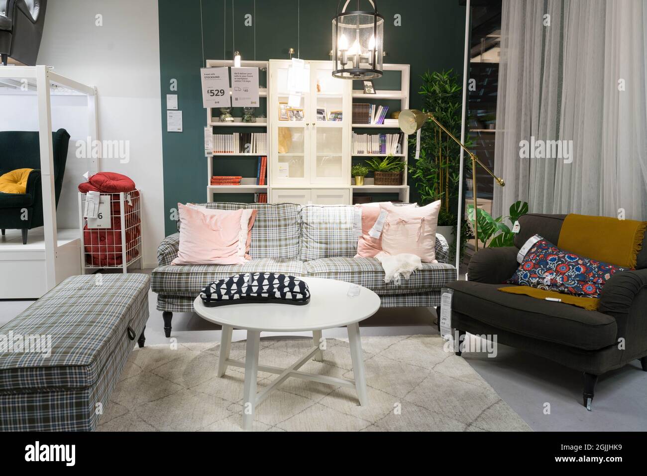 Sitting room with sofa, coffee table, armchair, reading light Stock