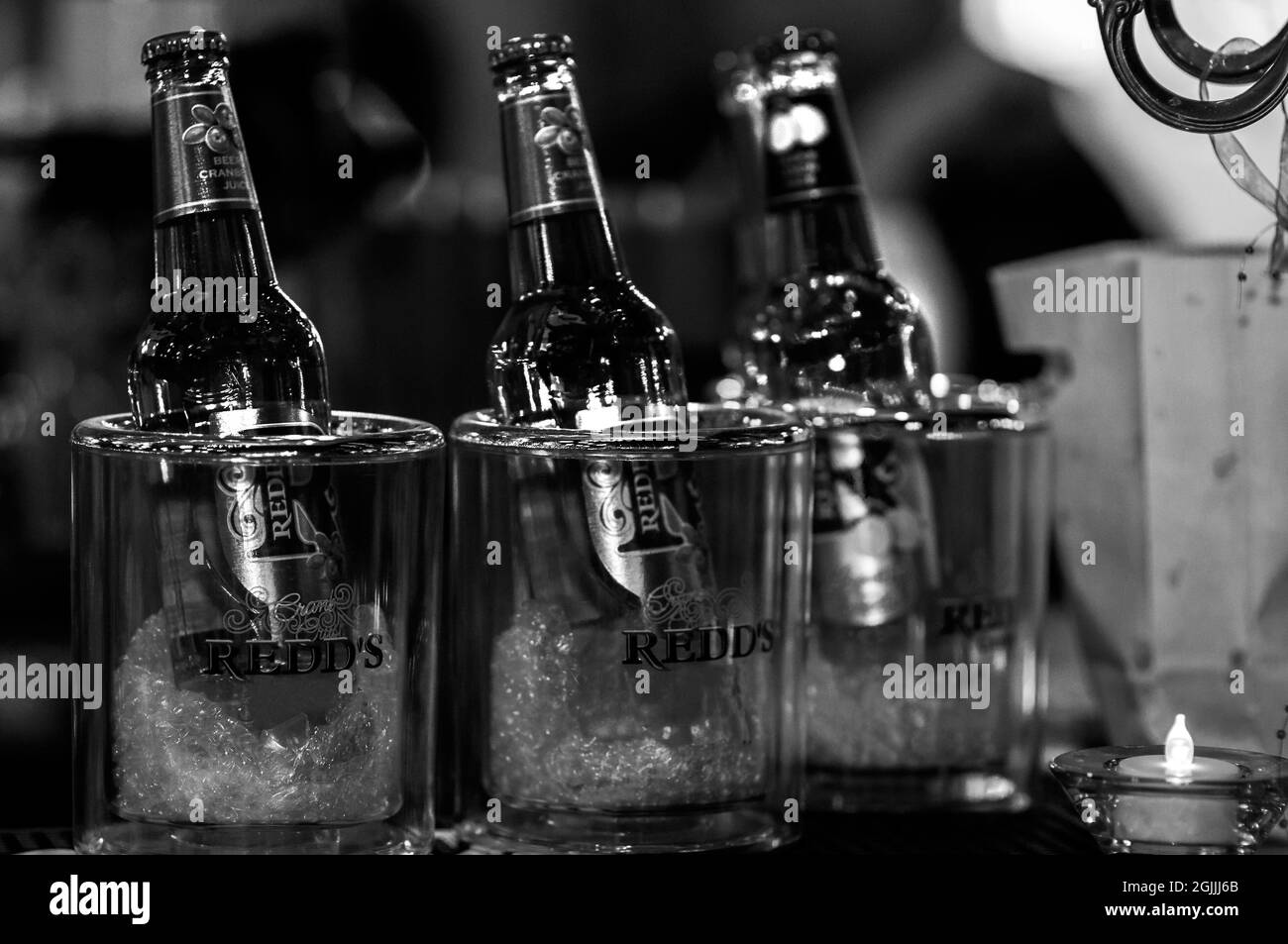 imisoara, Romania - 22-06-2021: Three beer of REDD's in twilight zone, kept in ice. Black and white image Stock Photo