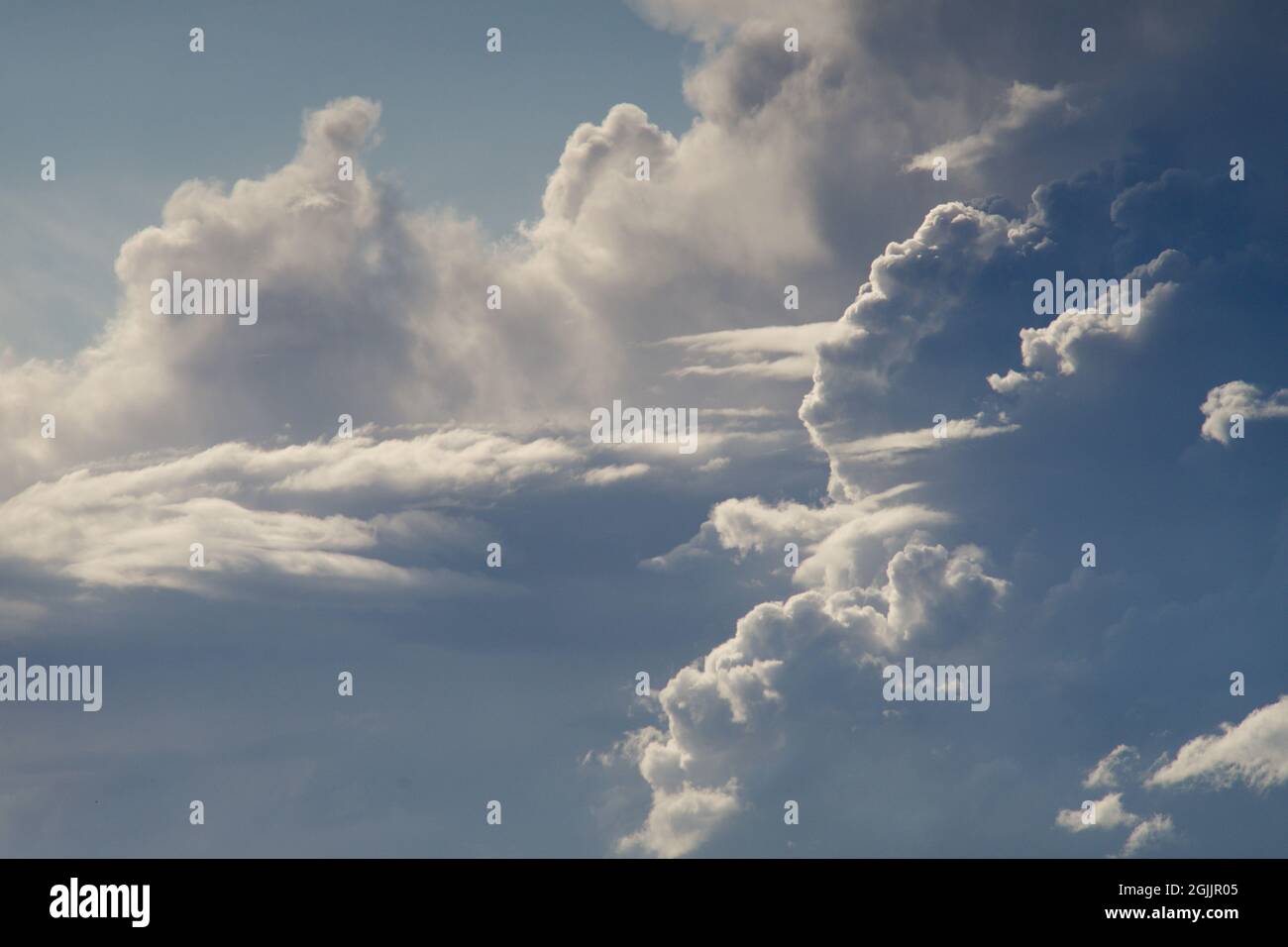 Blue sky with white and grey clouds Stock Photo - Alamy