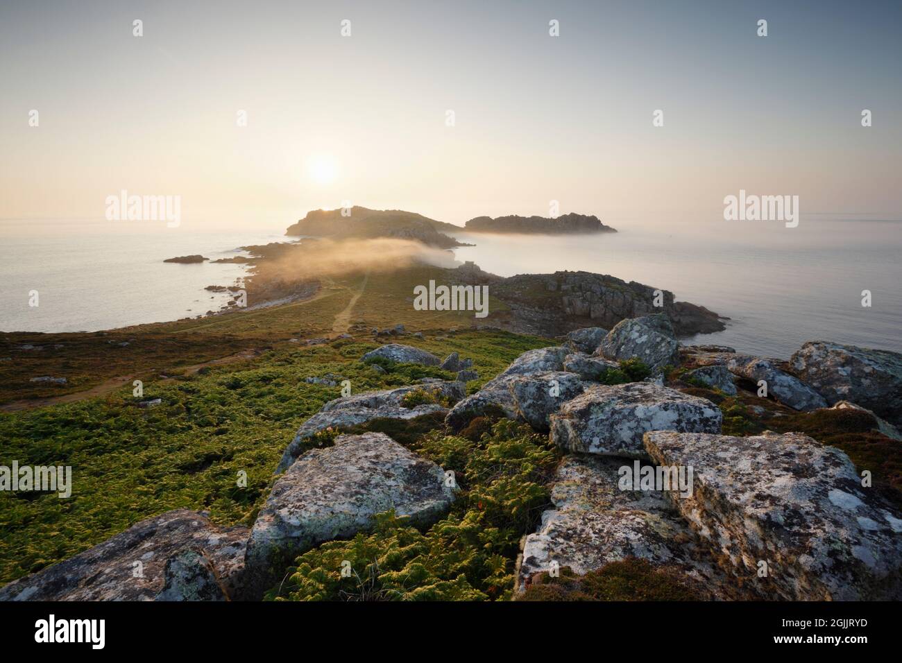 Sea mist at Shipman Head, sunset. Bryher. Isles of Scilly. Cornwall, UK. Stock Photo