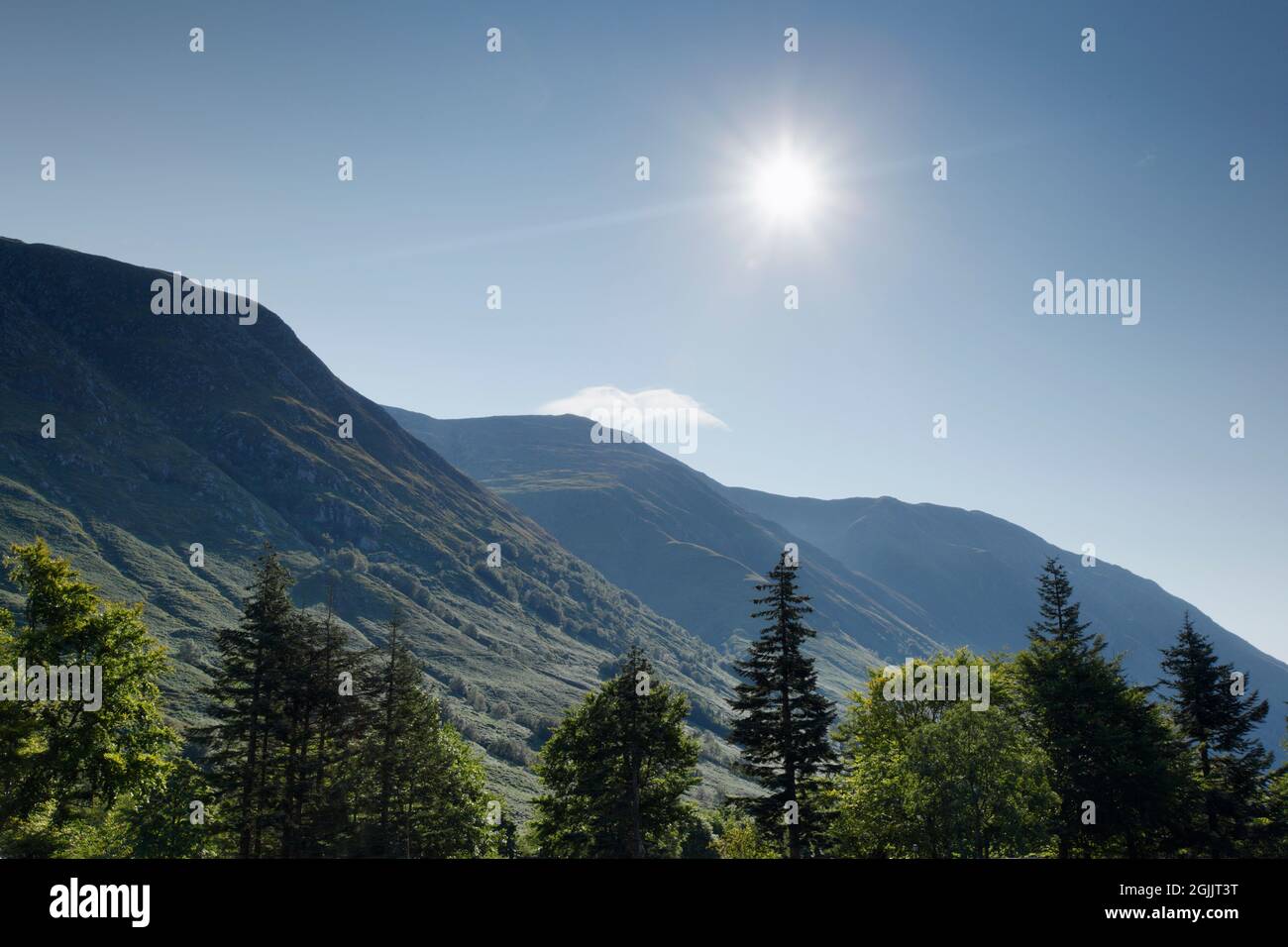 Morning Sun rises over Ben Nevis. Lochaber, Highland, Scotland, UK. Stock Photo