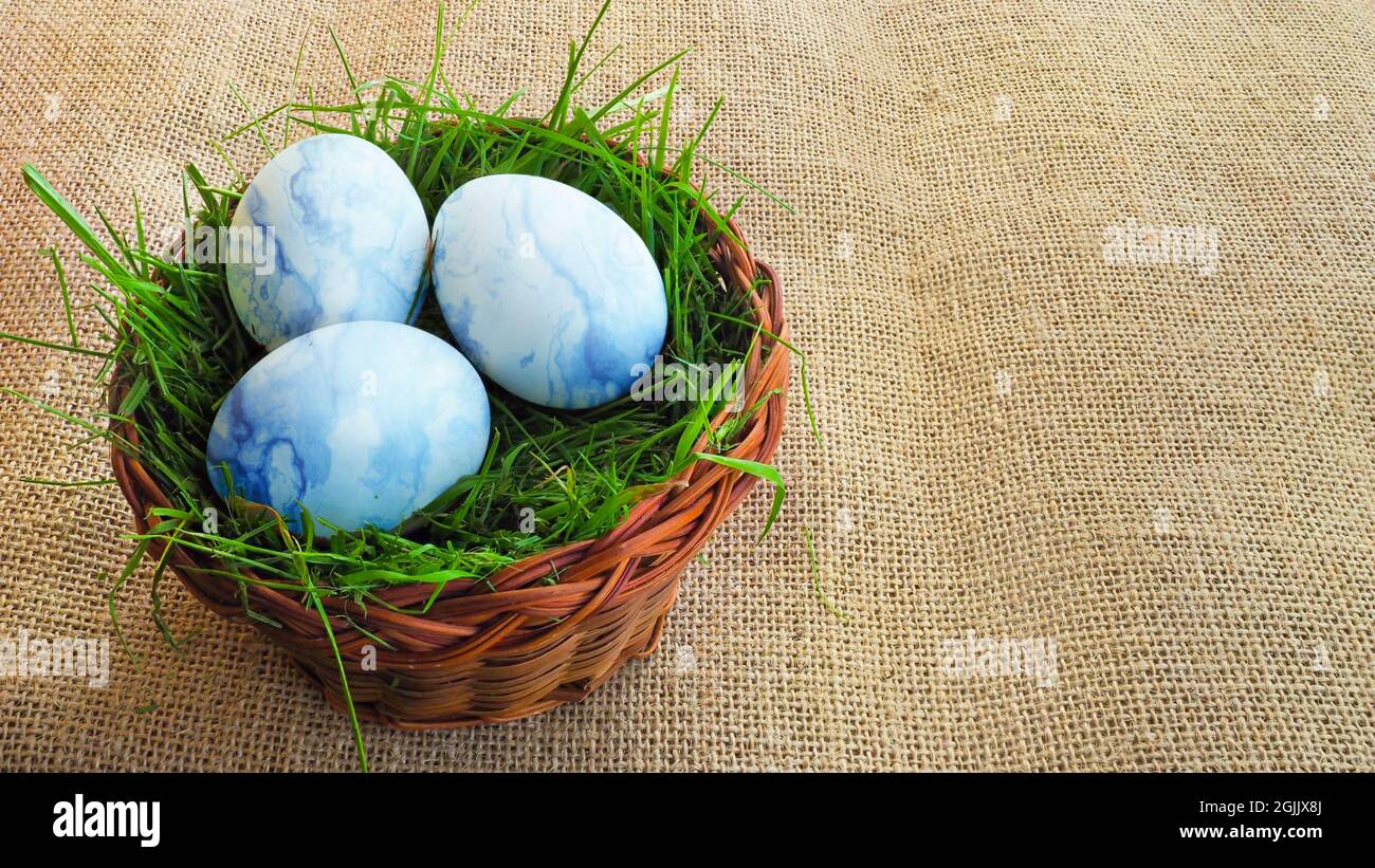 Basket with Easter eggs on a cloth. View from the top. Stock Photo