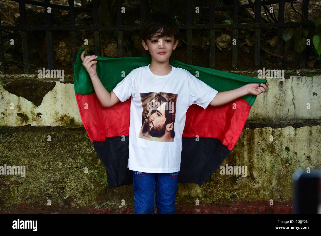 New Delhi, India. 10th Sep, 2021. A kid wearing a t-shirt with a picture of the slain former Mujahideen commander Ahmad Shah Massoud and his son during the demonstration. Afghan refugees standing in support of the Ahmad Massoud-led Resistance Force and protesting against Pakistan's offensive in Panjshir, Afghan people who live in New Delhi India, carried out a demonstration against the Taliban and Pakistan outside the Chanakyapuri police station. Credit: SOPA Images Limited/Alamy Live News Stock Photo