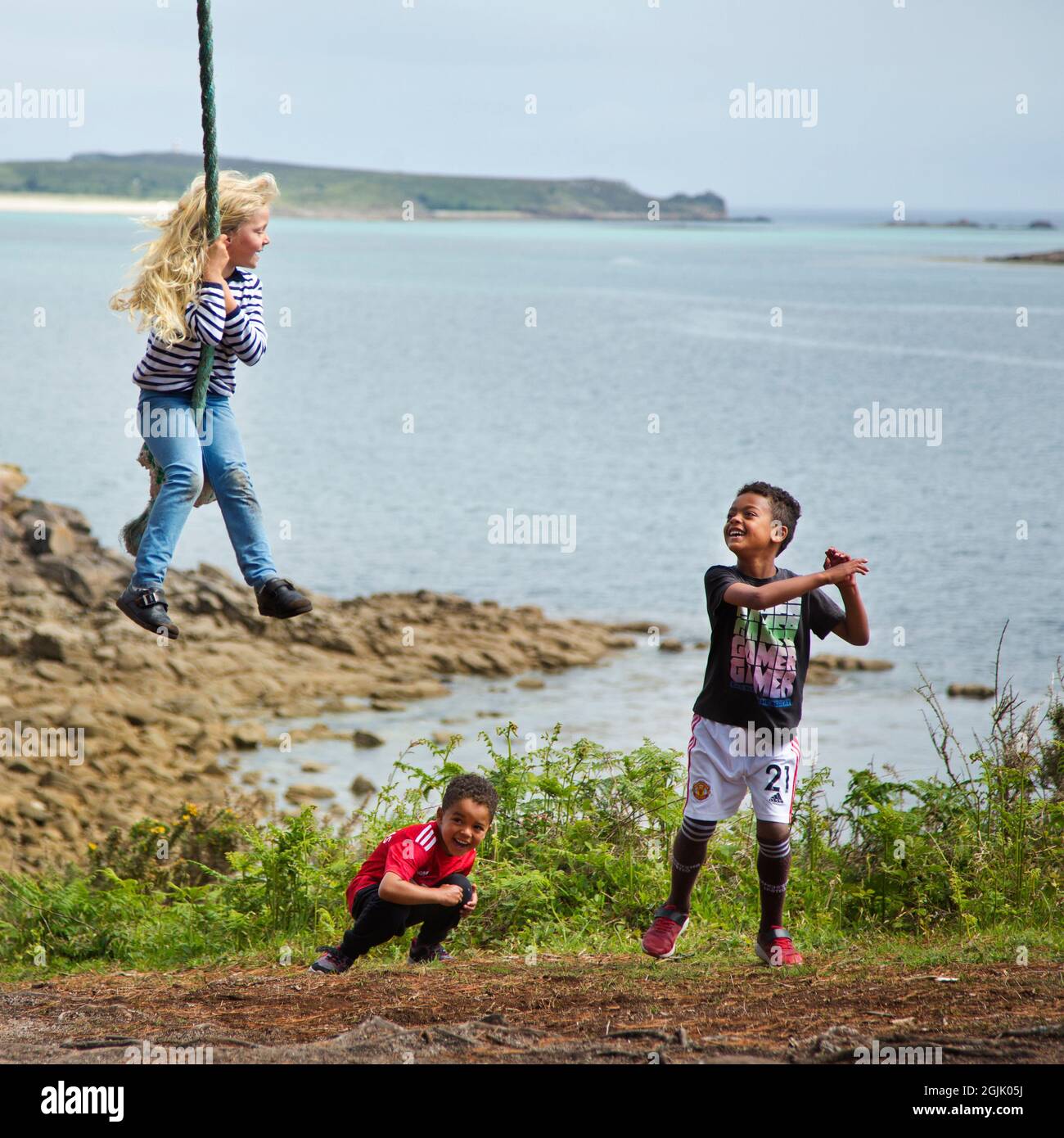 Three children from mixed race playing together Stock Photo