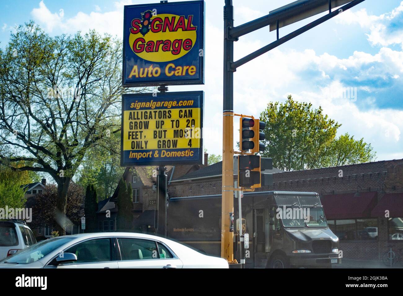 Signal Garage with humorous sign about alligator's feet. St Paul