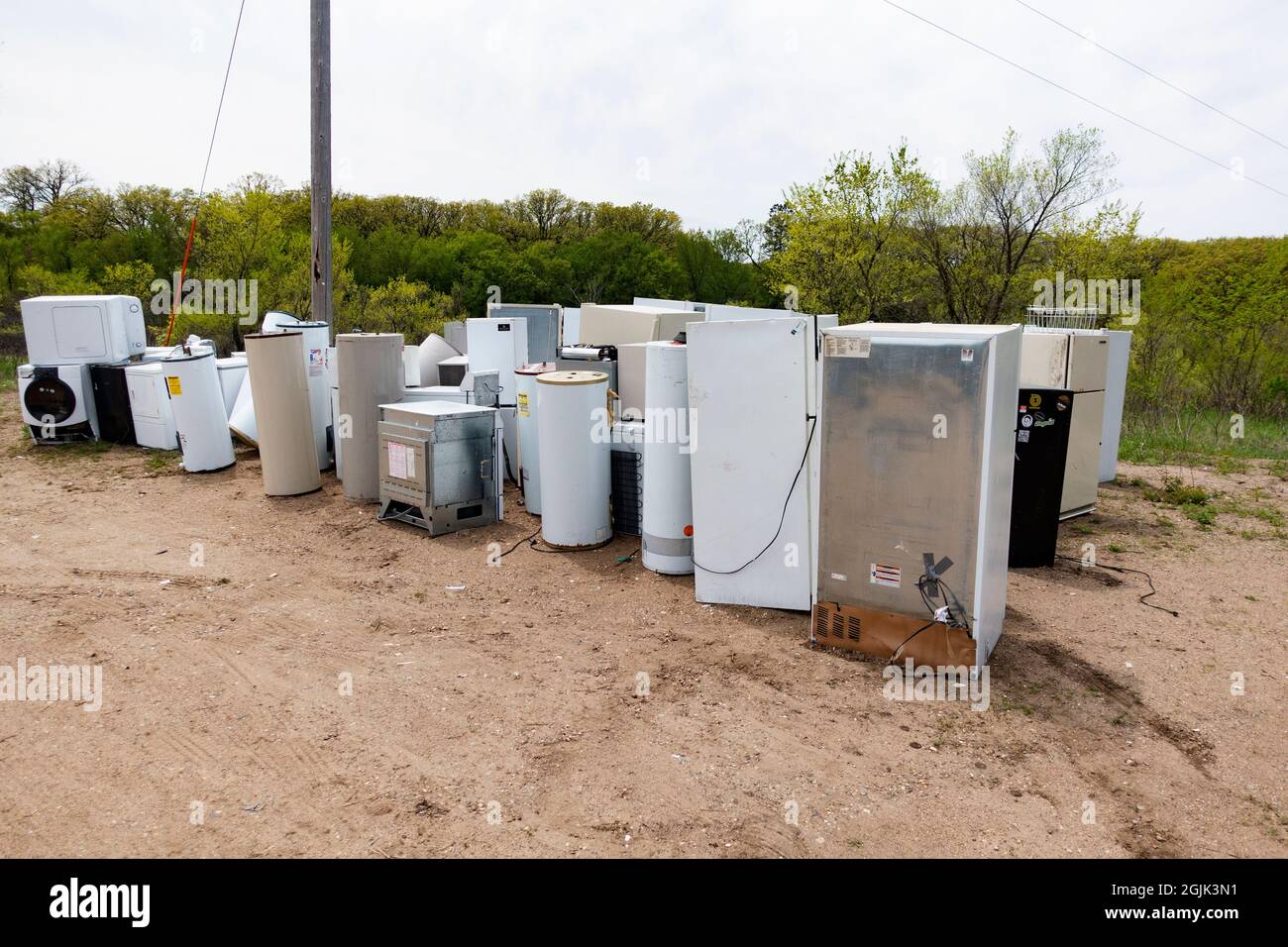 Group of not working white appliances at the Dump for recycling. Battle Lake Minnesota MN USA Stock Photo
