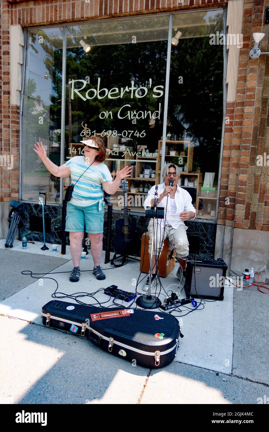 Woman singing with performing musician at the Grand Old Day street fair. St Paul Minnesota MN USA Stock Photo