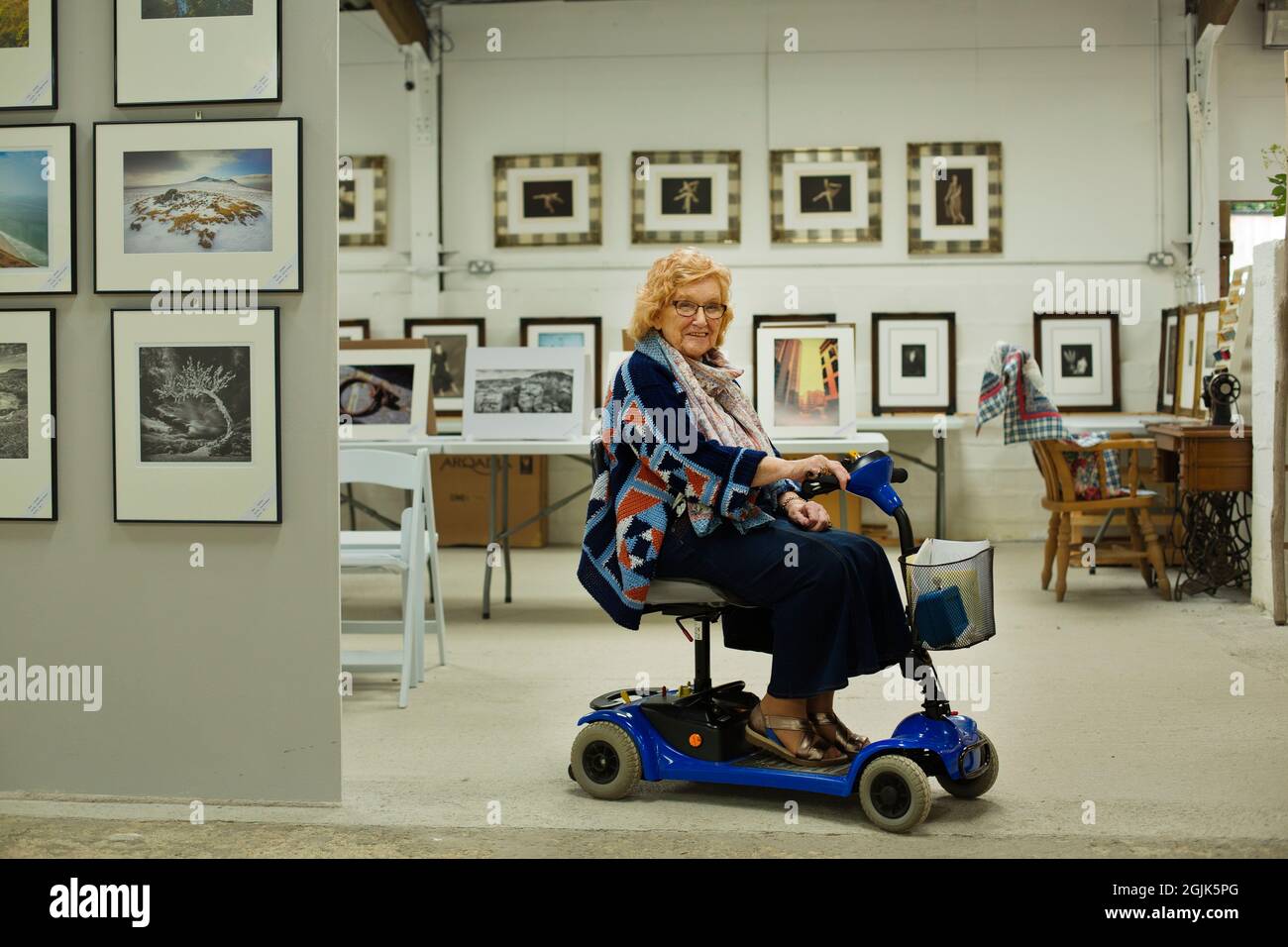 Disabled photographer at a photography exhibition Stock Photo