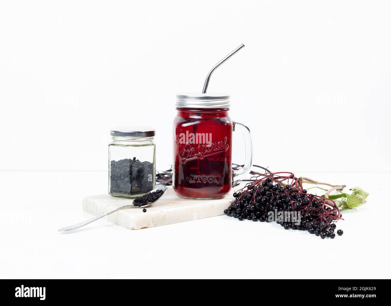 Elderberry tea in a mason jar. Dry and fresh berries of elderberry are