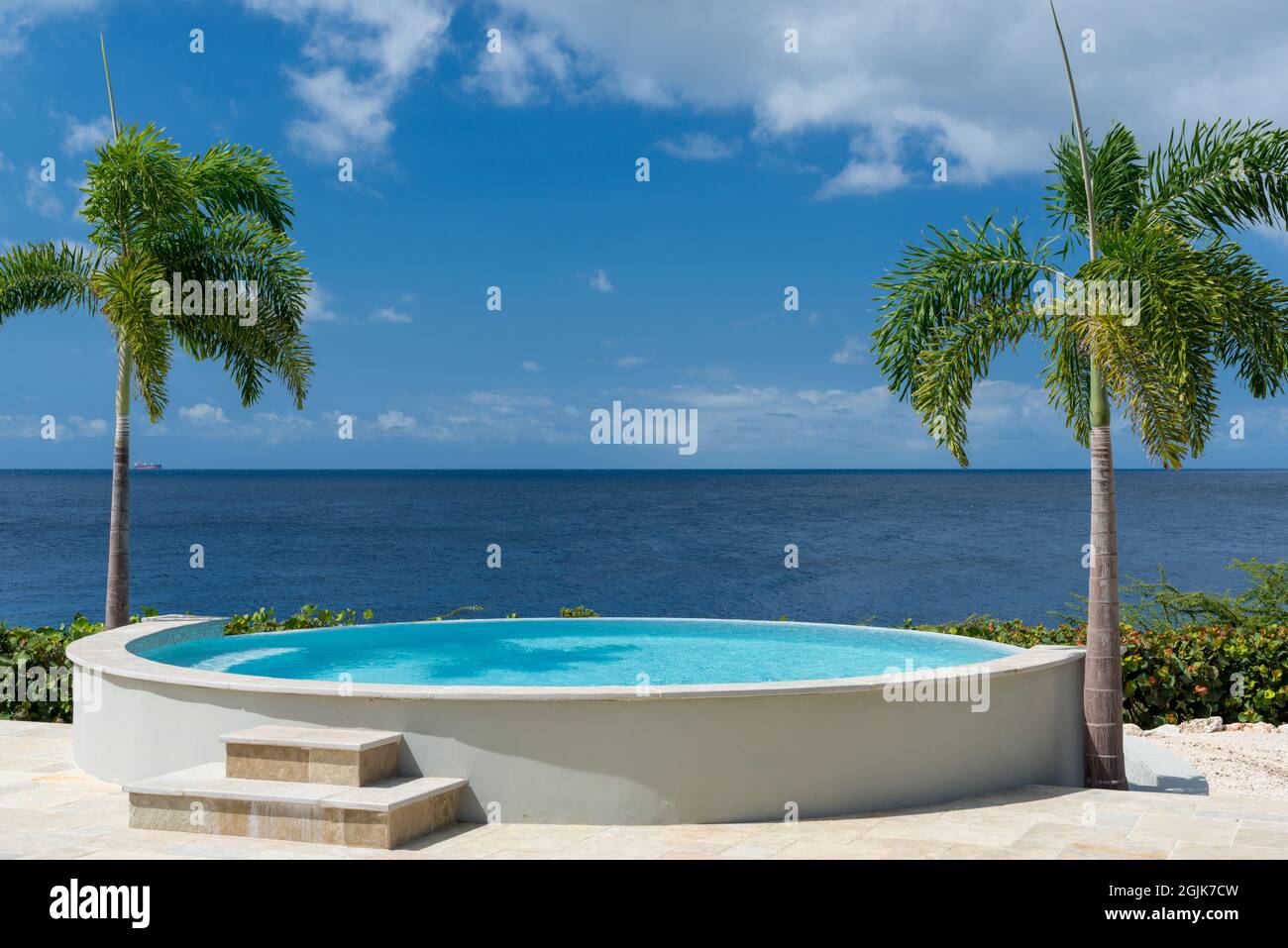 Summer and winter vacation destination, views of Curacao island, with private swimming poo, tropical flora and blue water of Carribean sea Stock Photo