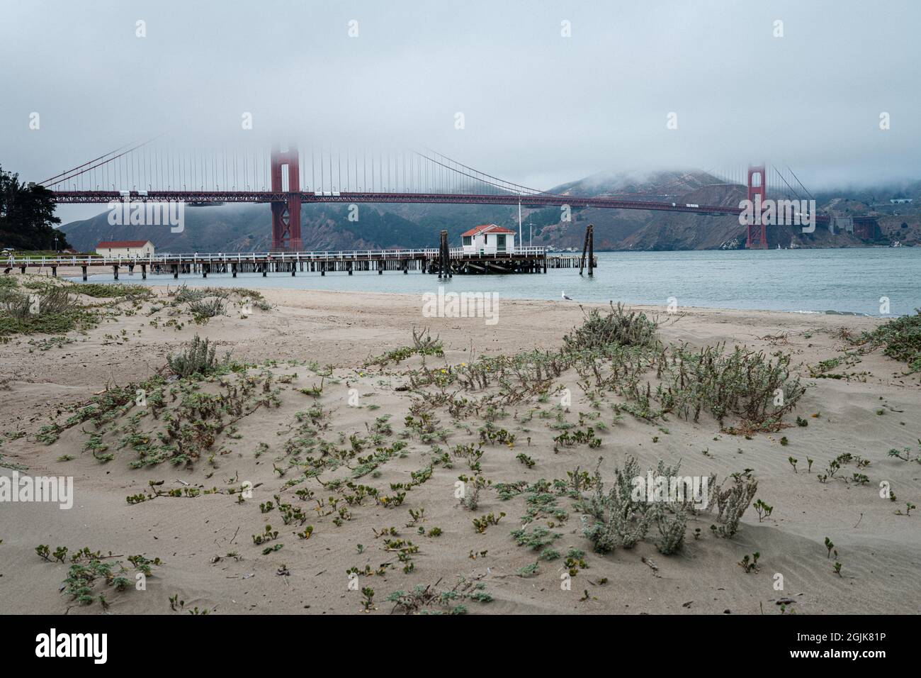 A view of the golden gate bridge from the sandy dunes on a misty tranquil summers day Stock Photo