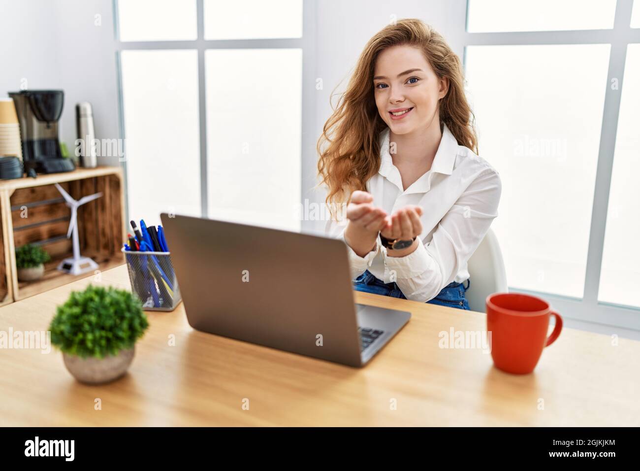 Young caucasian woman working at the office using computer laptop ...
