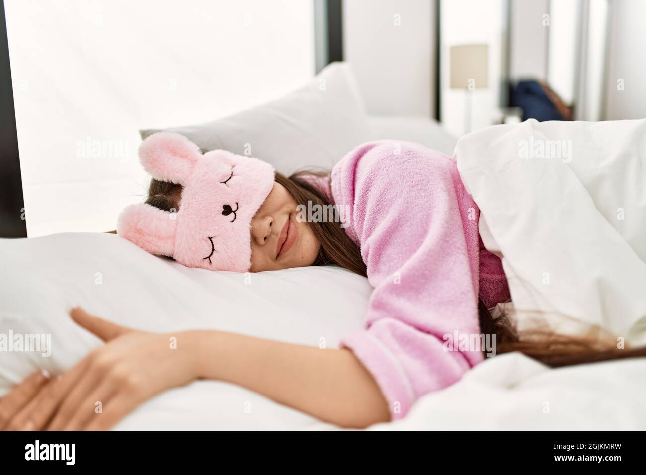 Young chinese girl wearing funny sleep mask sleeping on the bed at bedroom  Stock Photo - Alamy