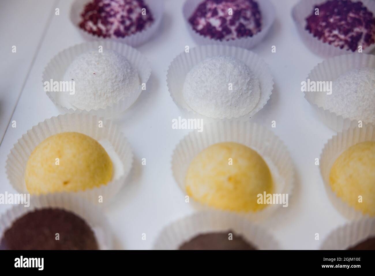 High angle shot of colorful desserts on a white counter Stock Photo - Alamy
