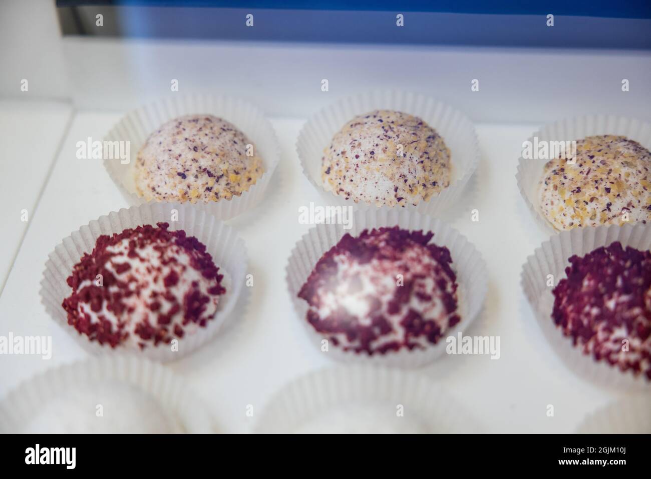 High angle shot of colorful desserts on a white counter Stock Photo - Alamy