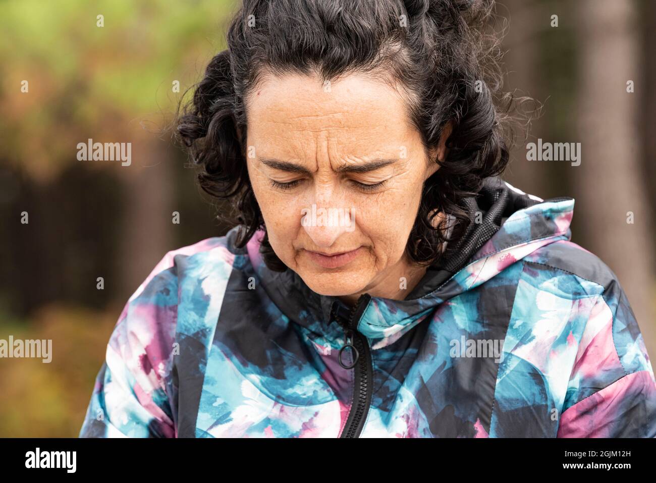 half-length portrait of a middle-aged white Caucasian woman with brown hair, dressed in rain gear. Stock Photo