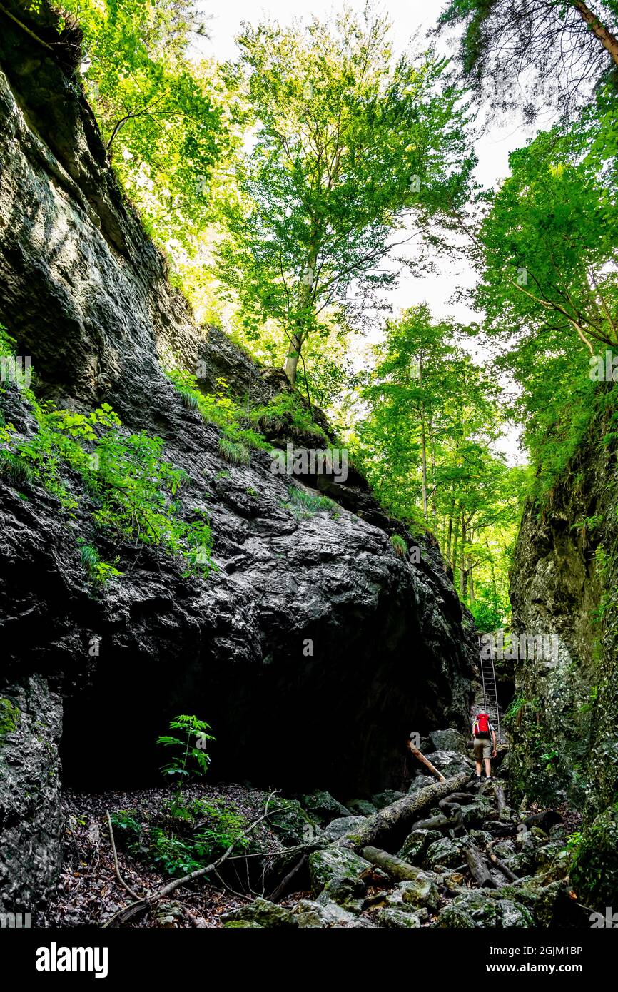 Woman climbing in narrow gorge hi-res stock photography and images - Alamy