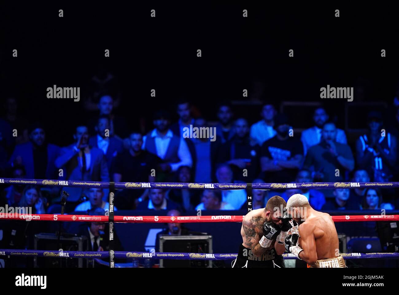 Spectators watch Sam Eggington (left) in action against Bilel Jkitou in the World Boxing Council Silver Middle Title during the boxing event at the Coventry Skydome Arena. Picture date: Friday September 10, 2021. Stock Photo