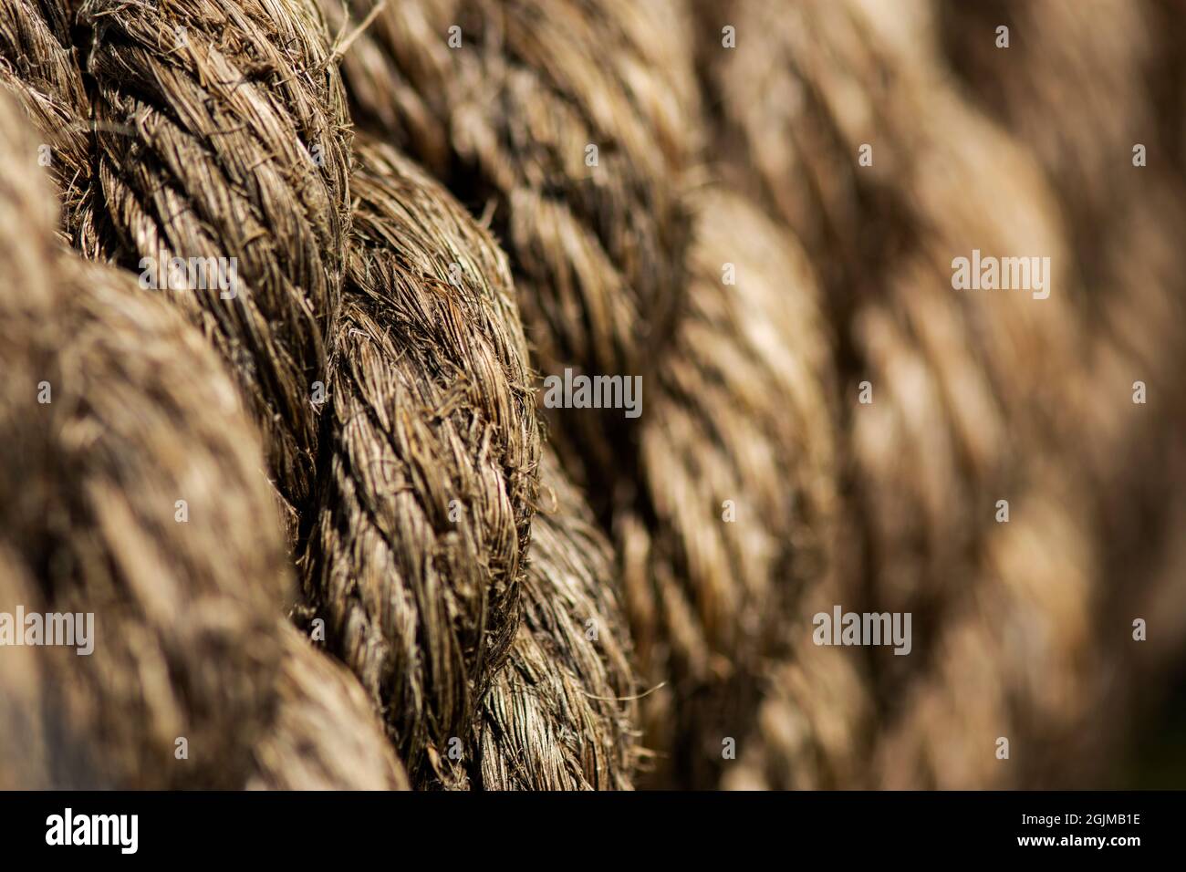 Old marine rope coiled around an object Stock Photo - Alamy