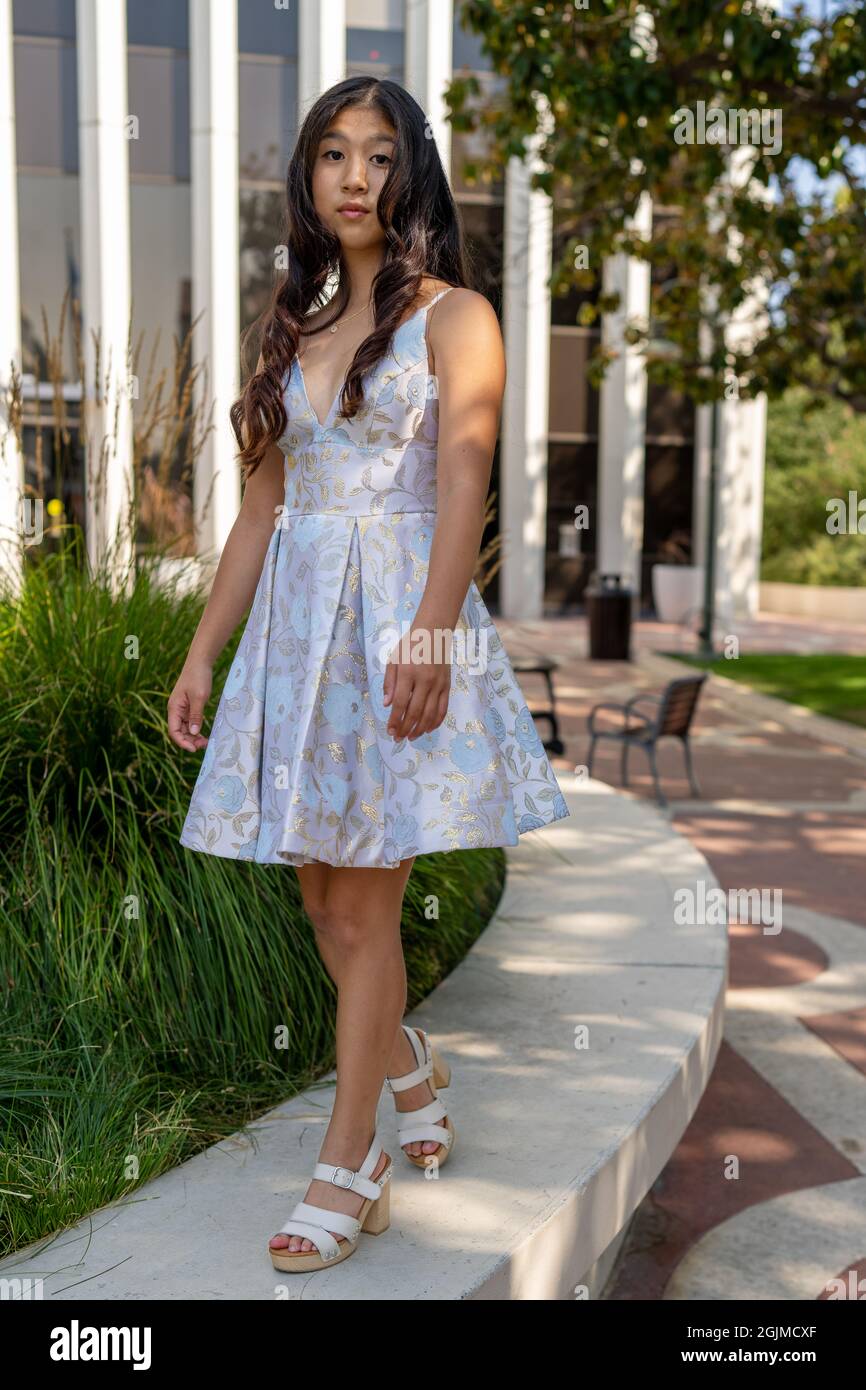 Teenage Asian Girl Walking Around Park in Sweet 16 Dress Stock Photo