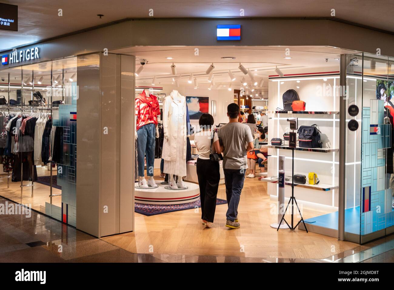 Hong Kong, China. 07th Aug, 2021. Shoppers walk in the American  multinational clothing fashion brand, Tommy Hilfiger store seen in Hong  Kong. (Photo by Budrul Chukrut/SOPA Images/Sipa USA) Credit: Sipa USA/Alamy  Live