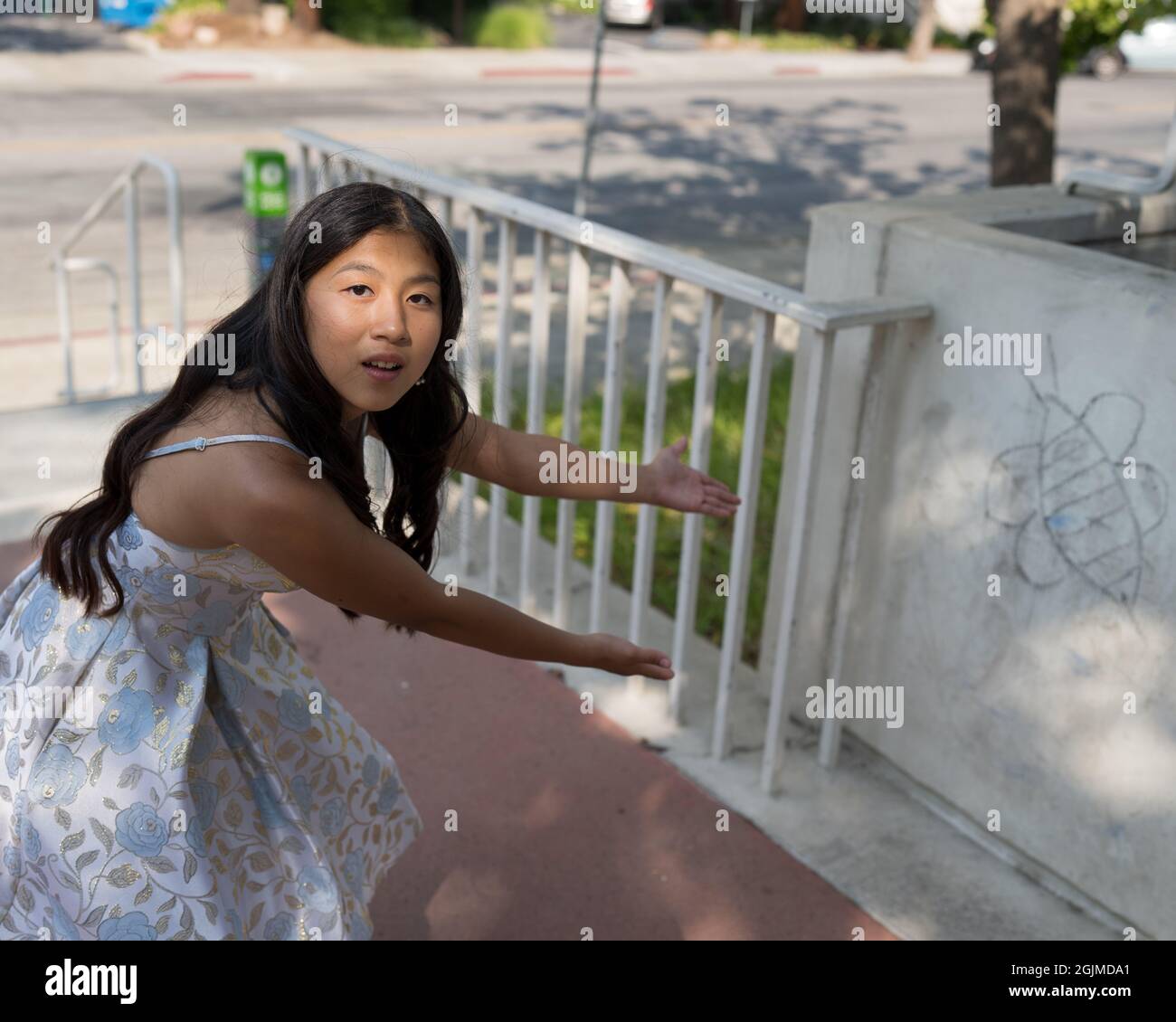 Teenage Asian Girl Admiring Odd Things Stock Photo