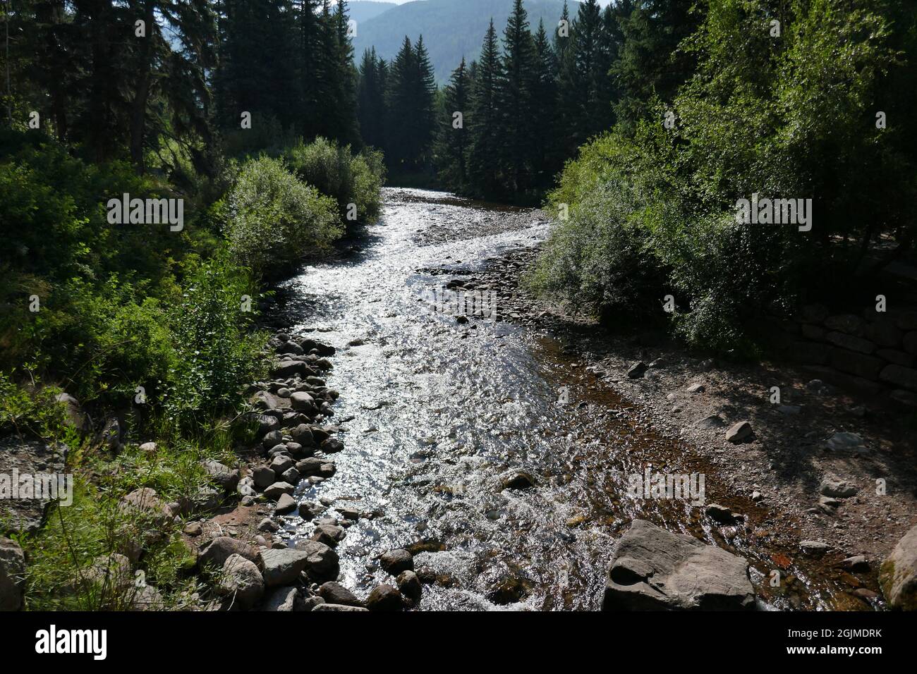 Beautiful mountain natural scenery with large creek flowing through Stock Photo