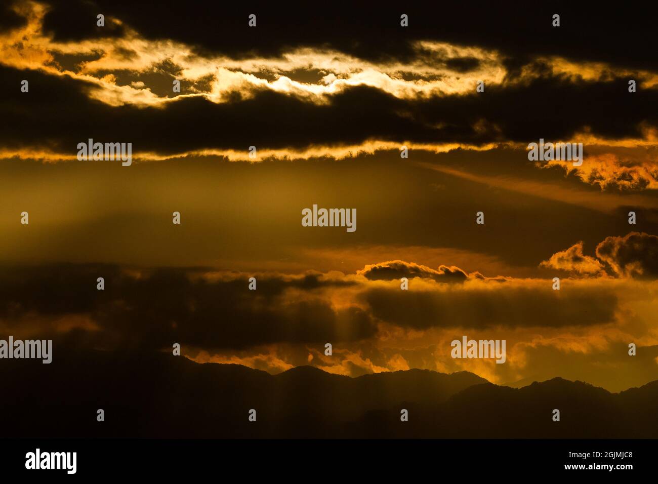 Sunset clouds at dusk over mountains in  Japan. Stock Photo