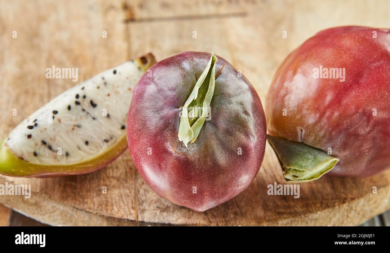 Peruvian apple cactus fruits whole and cut on wooden stand on gray board.  Scientific name Cereus repandus Stock Photo - Alamy