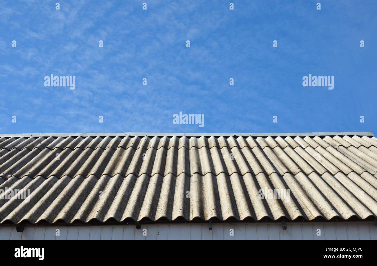 Asbestos roof removal. Asbestos house roofing construction Stock Photo