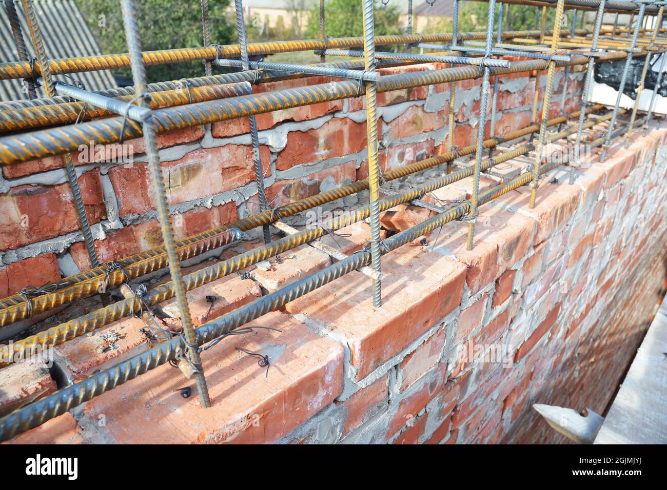 Reinforcement corner concrete bars with wire rod. Brickwork with Iron Bars for House Construction. Stock Photo