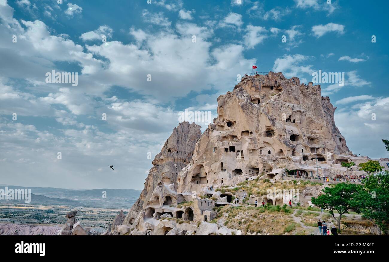 Natural formation of volcanic remains in stone and cave made of human inside edge castle (uchisar) in cappadocia with magnificent sky background Stock Photo