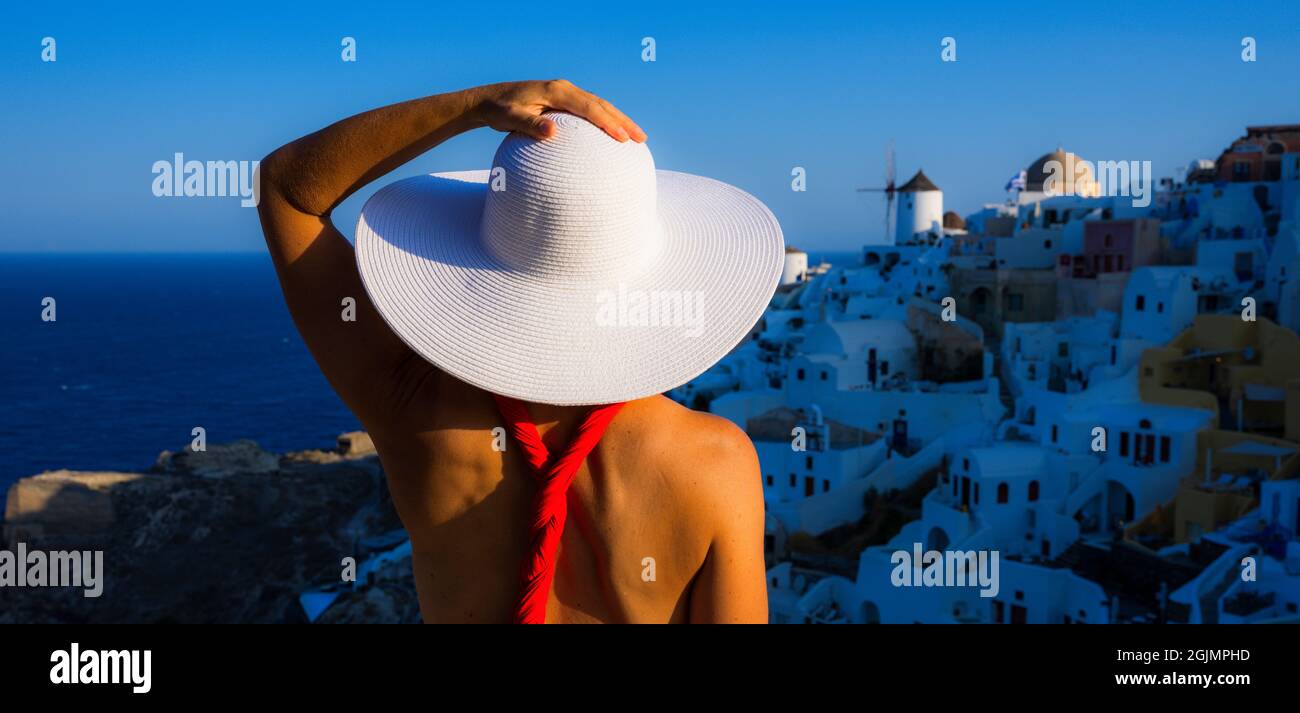 woman with white hat in Oia, Santorini, Greece Stock Photo