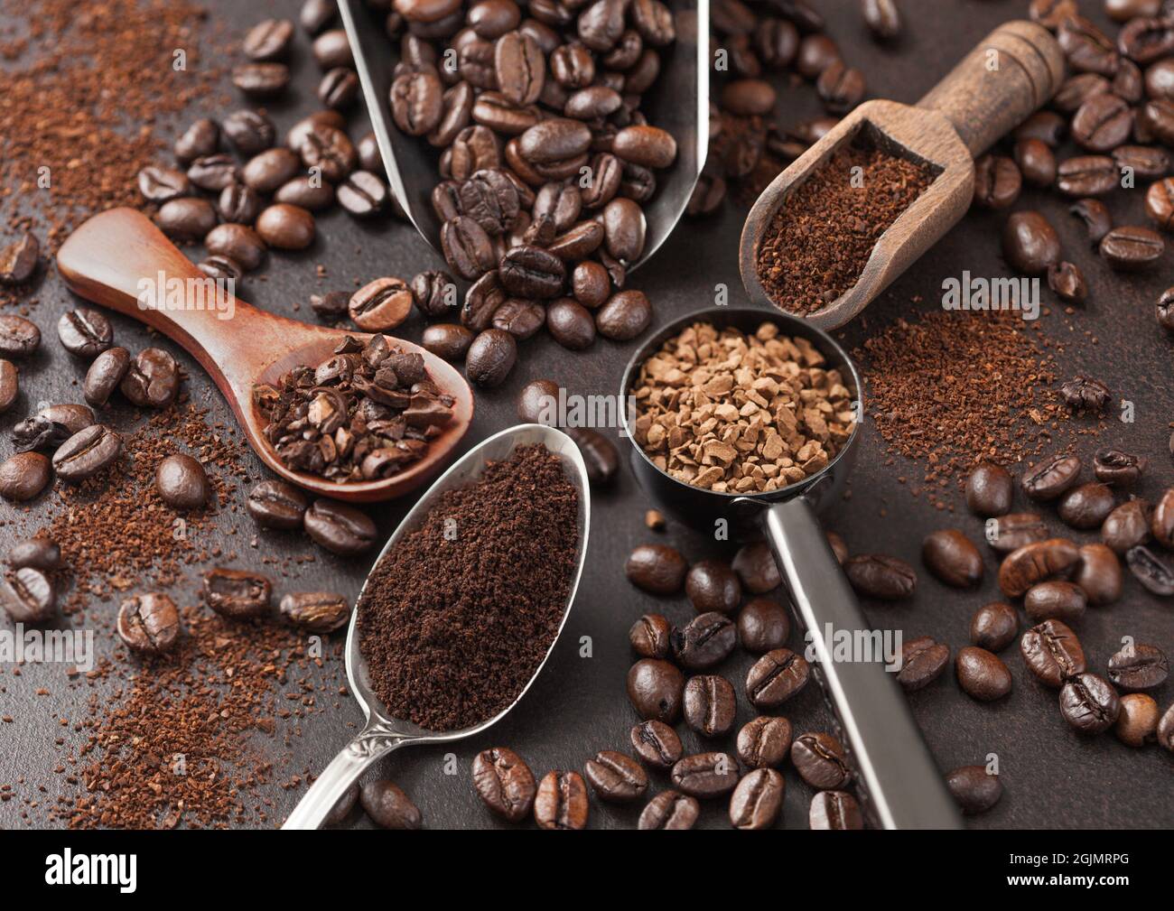 Various scoops with ground and bean coffee and freeze dried instant