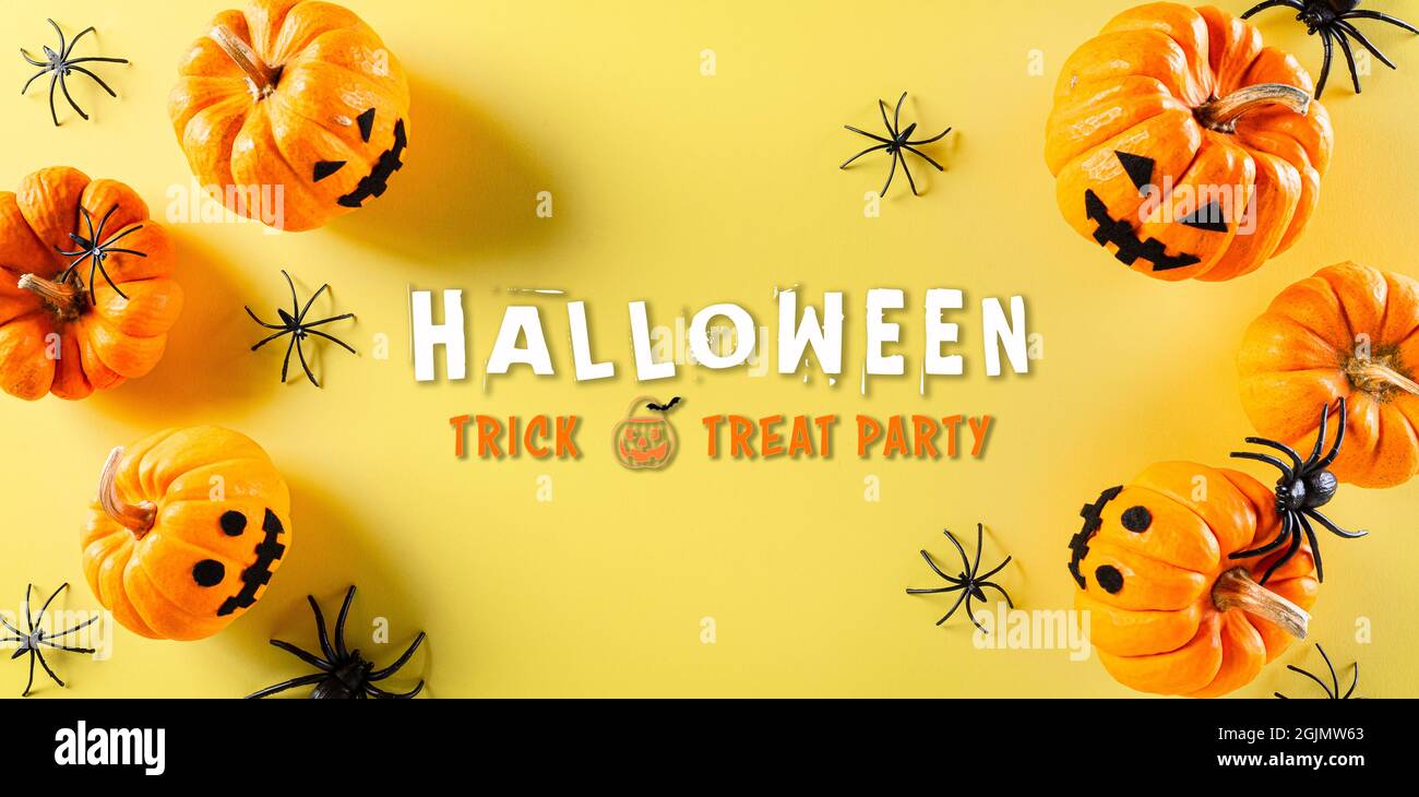 Top view of Halloween crafts, orange pumpkin, ghost, bat and black ...
