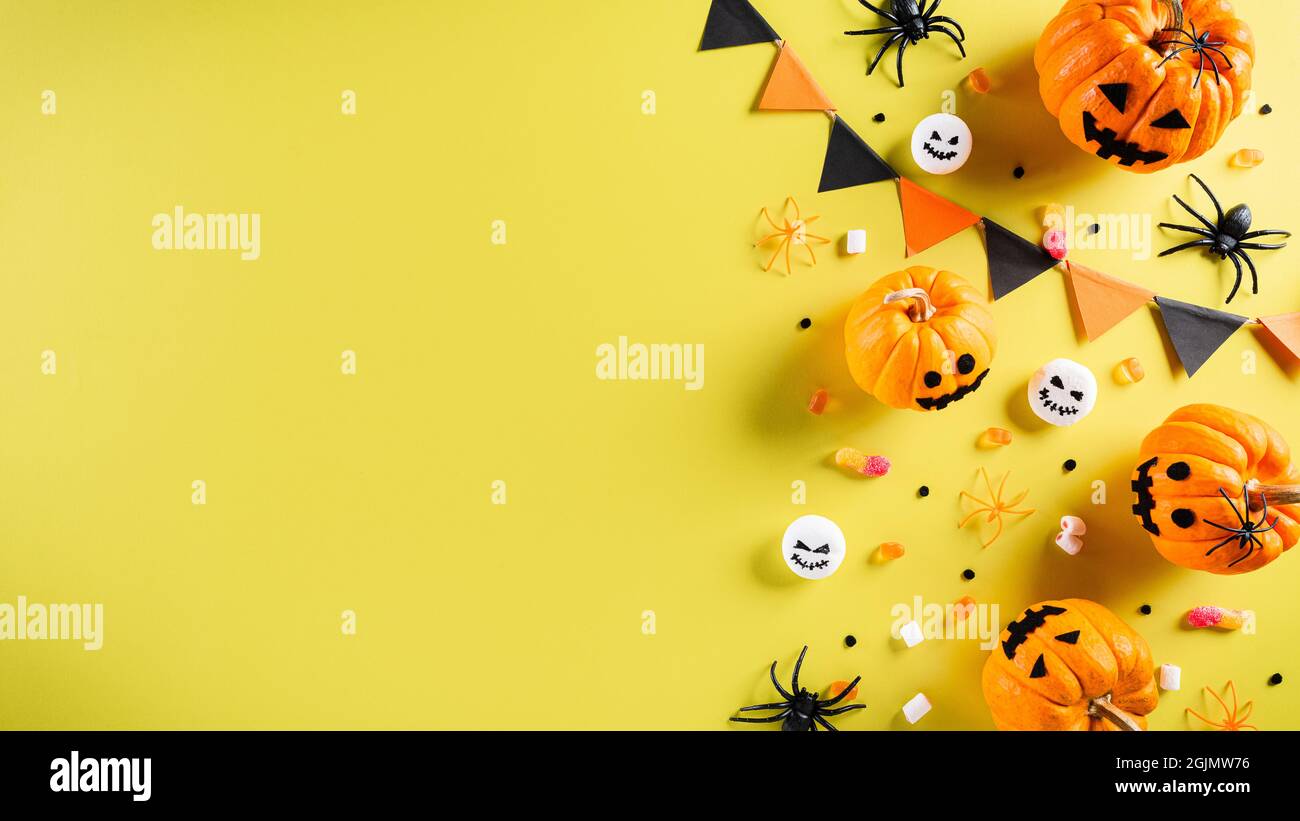 Top view of Halloween crafts, orange pumpkin, ghost, bat and black ...
