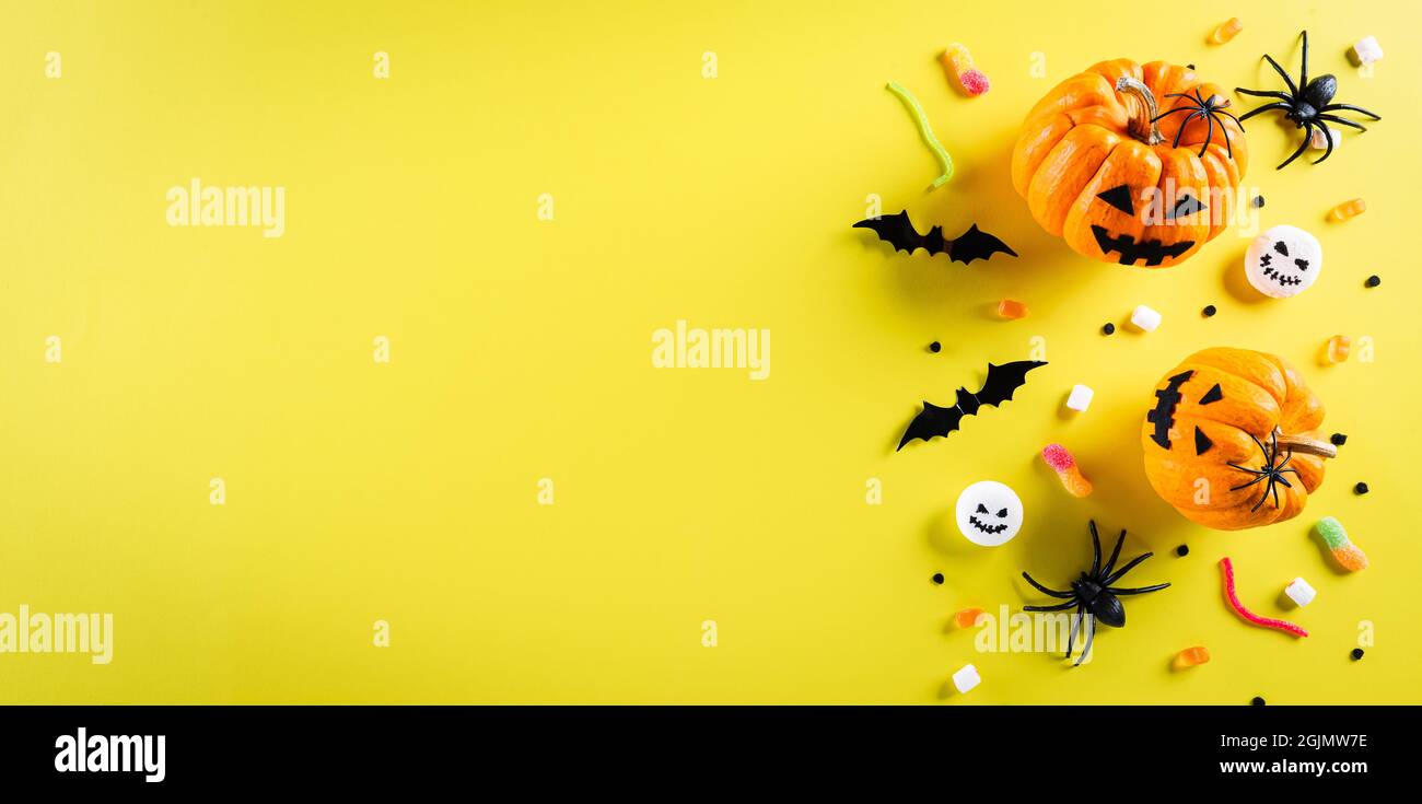 Top view of Halloween crafts, orange pumpkin, ghost, bat and black ...