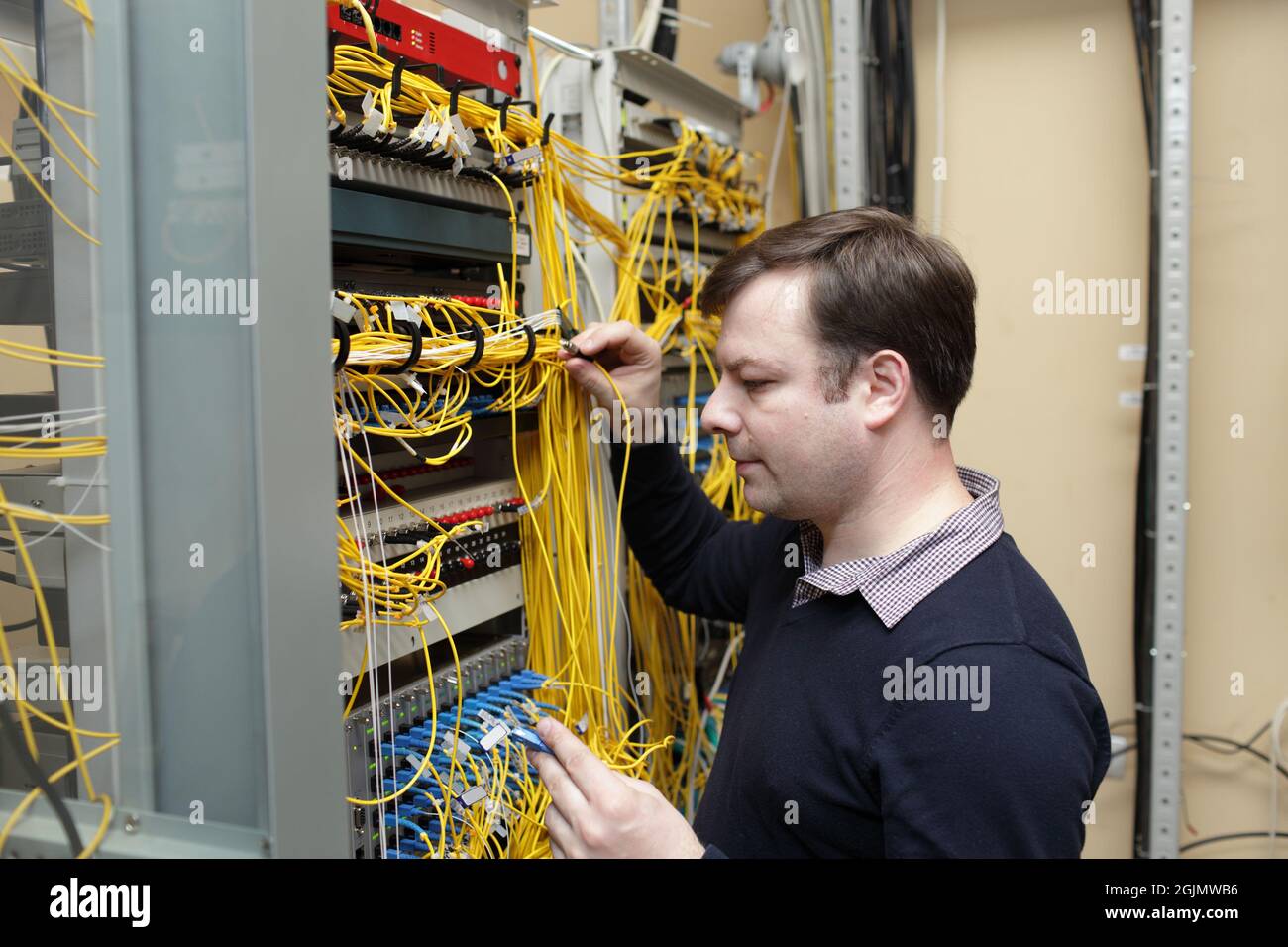 The network engineer jumpering fibre optic on optical distribution frame Stock Photo