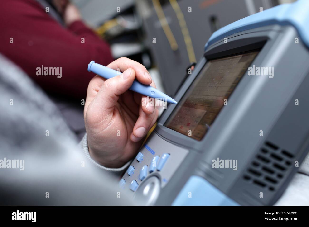 The technician holding a telecom analyzer at site Stock Photo