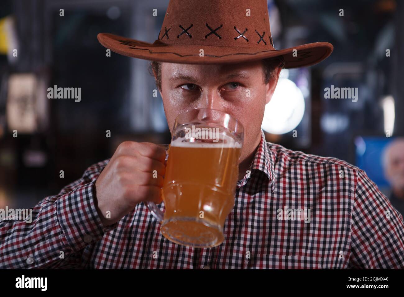 wearing cowboy hat drinking beer 