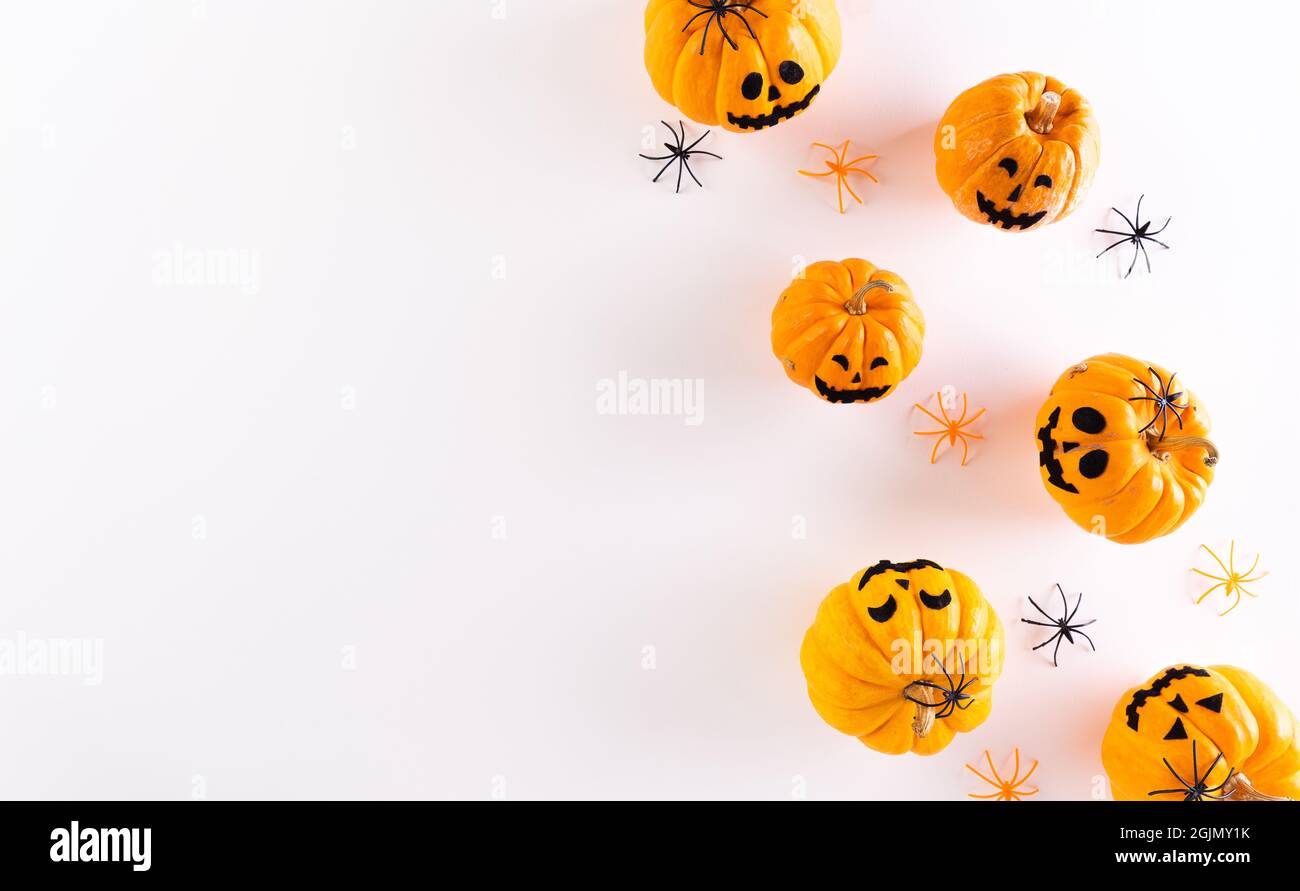 Top view of Halloween crafts, orange pumpkin, ghost, bat and spider on ...