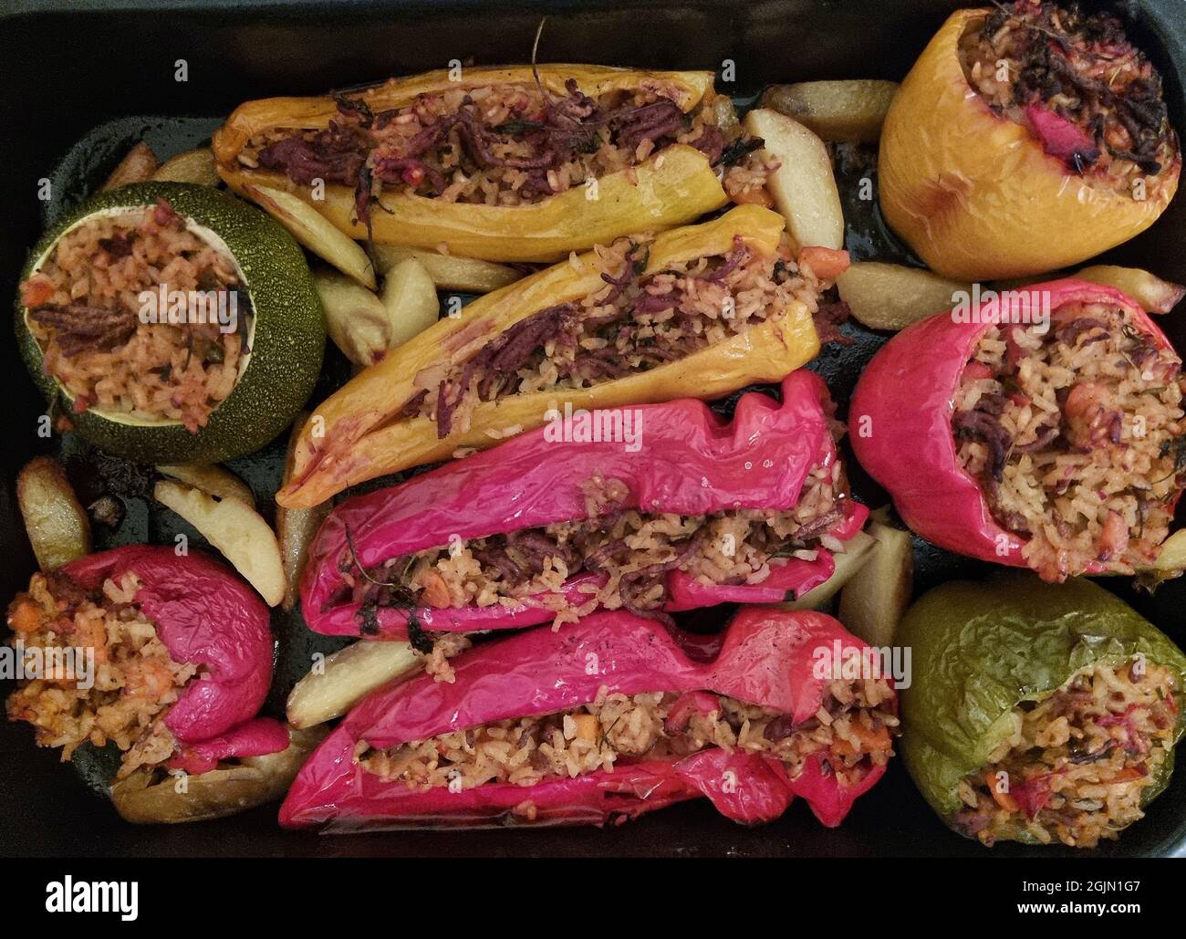 Gemista or yemista (which in Greek means 'filled with')  a traditional recipe for Greek stuffed tomatoes and other vegetables that are baked, until so Stock Photo