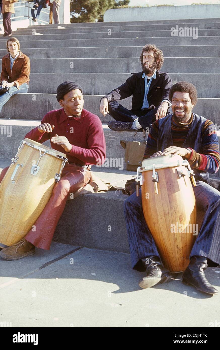 USA San Francisco 1968. Three men are playing on drums while a man is sitting in the background meditating. Kodachrome slide original.   Credit Roland Palm ref 6-1-19 Stock Photo