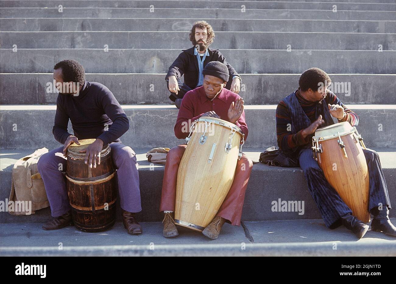USA San Francisco 1968. Three men are playing on drums while a man is sitting in the background meditating. Kodachrome slide original.   Credit Roland Palm ref 6-1-18 Stock Photo